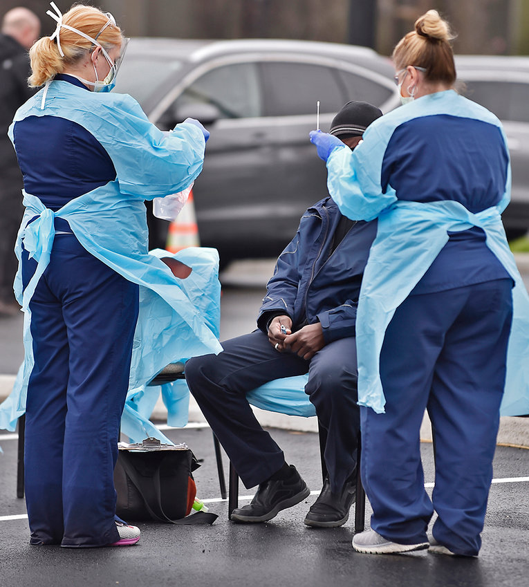 Nurses with Christiana Care, Delaware's largest health care system, administer a free test for the coronavirus (COVID-19) to a man at the Riverfront complex in downtown Wilmington on March 13th.