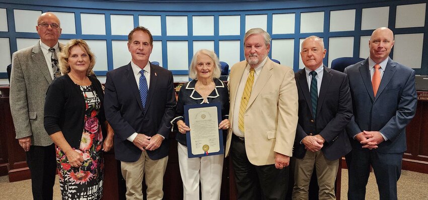 On Tuesday, Kitty Cole holds the Sussex County Council proclamation in honor of her 100th birthday July 7. Joining her are, from left, council members Michael Vincent, Cindy Green, Mark Schaeffer, John Rieley and Doug Hudson and county administrator Todd Lawson.