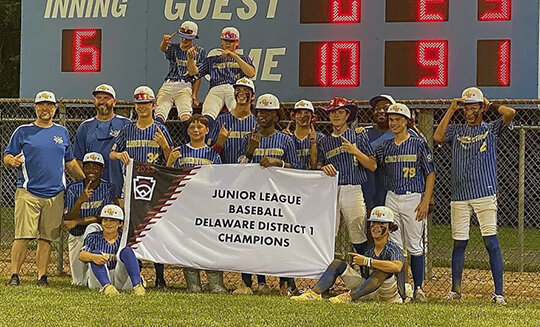 The Camden-Wyoming all-stars pose with their Junior League District I championship banner. Submitted photo.