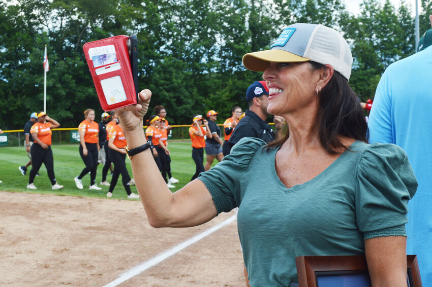 Michelle Freeman of the Carl M. Freeman Foundation, a longtime sponsor of the Little League Senior Softball World Series in Roxana, captures closing festivities at Monday's opening ceremonies.