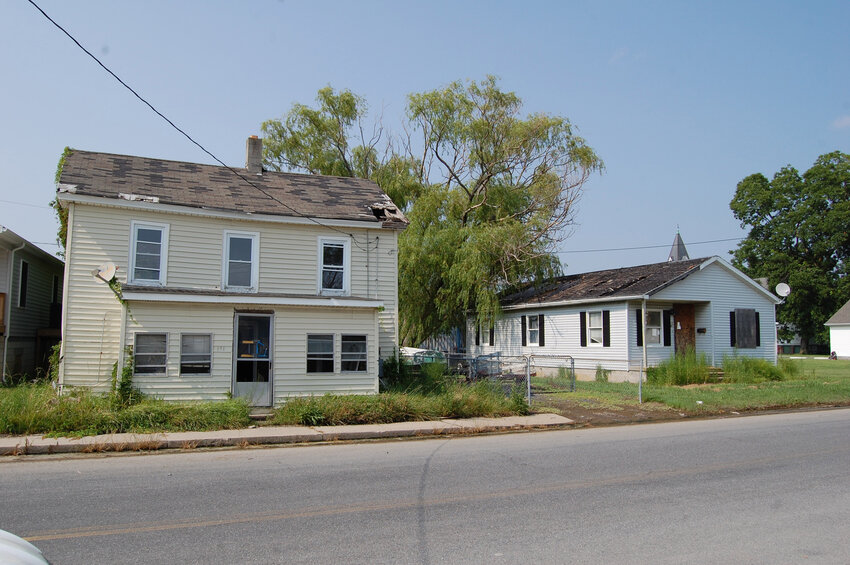 These houses at 232, left, and 230 Broadway in Crisfield were turned over by the county to the city with the county agreeing to waive the tipping fee for demolition debris. The house on the left will be replaced by the Eastern Shore Long Term Recovery Committee with a new owner anticipated to be moved in by year-end.