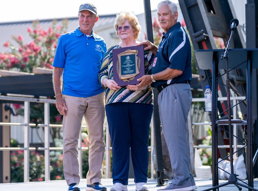 Delaware Secretary of Agriculture Michael T. Scuse, right, and Gov. John Carney present Katherine &ldquo;Kitty&rdquo; Holtz with the Secretary&rsquo;s Award for Distinguished Service to Agriculture during Governor&rsquo;s Day festivities Thursday at the Delaware State Fair.