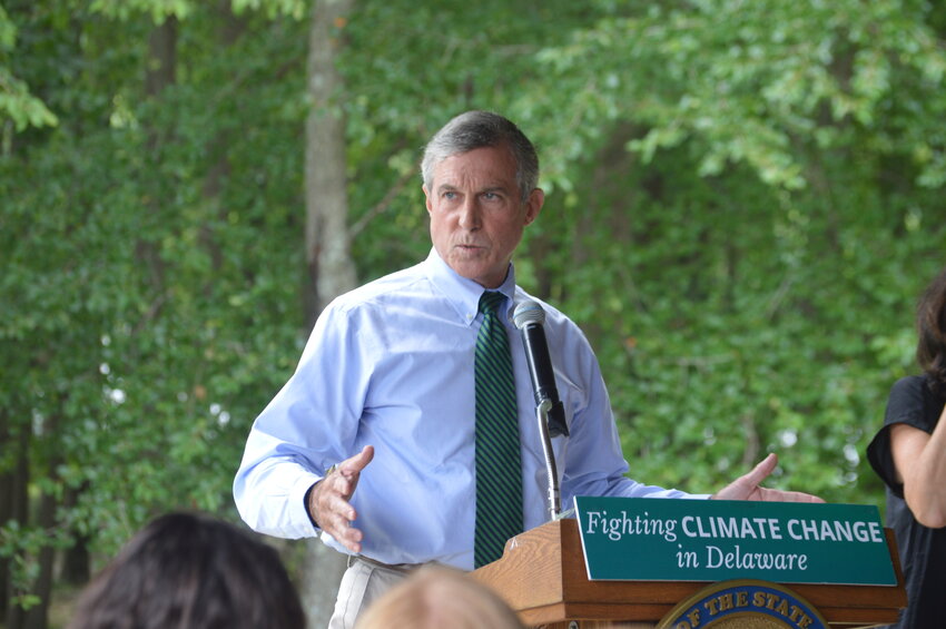 Gov. John Carney signed seven bills into law at Lums Pond State Park Thursday that aid the state&rsquo;s greenhouse gas reduction goals and help build out the state&rsquo;s electric vehicle infrastructure.