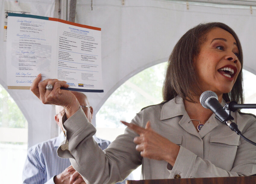 U.S. Rep. Lisa Blunt Rochester points to the program during her address at the Springboard Collaborative Pallet Shelter Village celebration Friday.