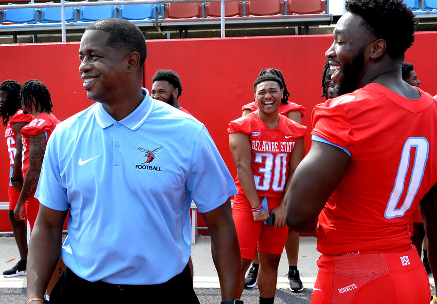 Delaware State University head football coach Lee Hull enjoying a lighter moment with linebacker Charles Brown, of Edgewood, Md. GARY EMEIGH/SPECIAL TO THE DELAWARE STATE NEWS