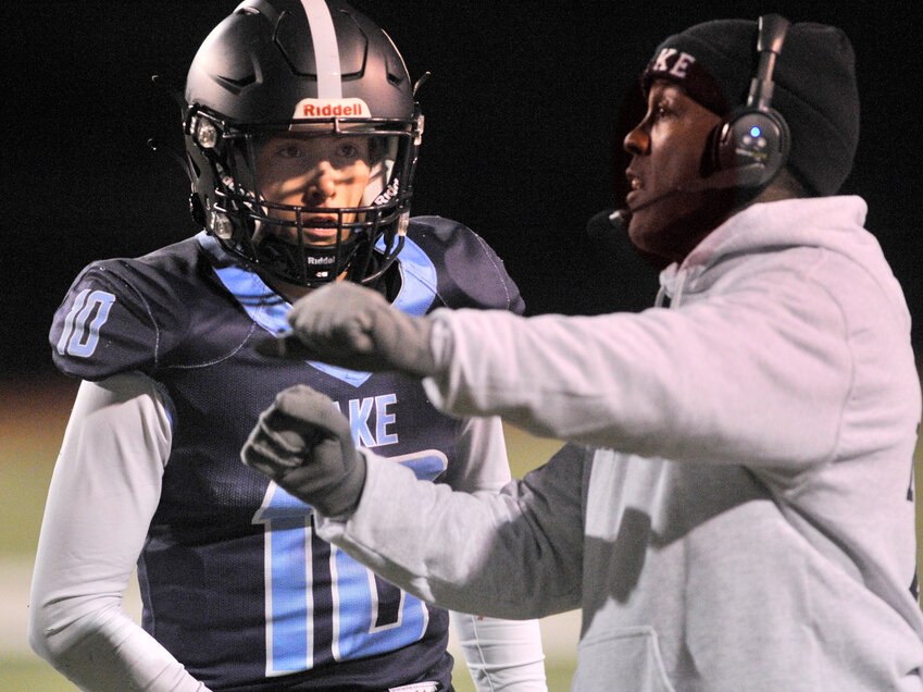 Lake Forest head football coach Fred Johnson giving quarterback Jonathan Tyndall a play in a game last year. Special to the Delaware State News/Gary Emeigh.