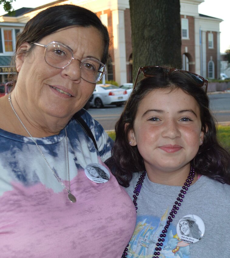 With her grandmother, Teressa Payne, 10-year-old Aurora Palverento, who lost both of her parents to drug overdoses, was a speaker at an International Overdose Awareness Day event in Georgetown on Thursday. Aurora is wearing a picture of her mom, who died in 2016.