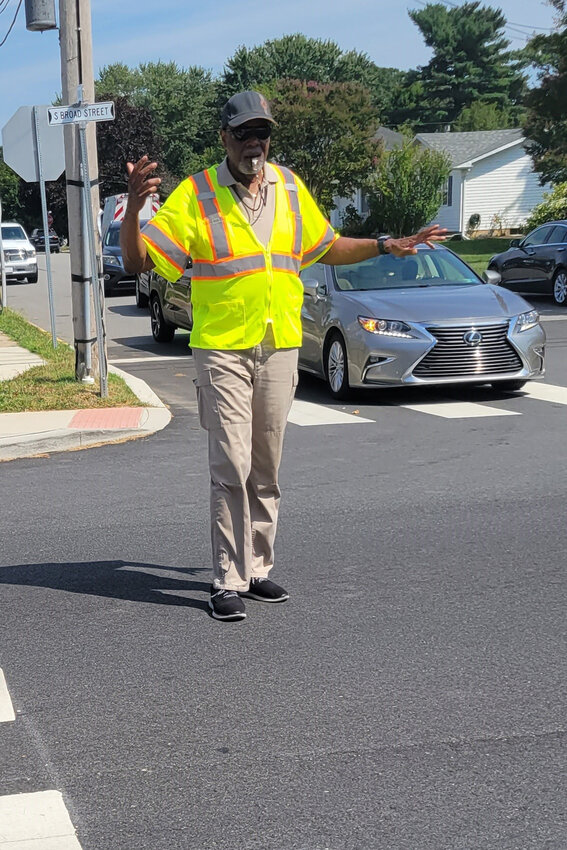 Crossing guard Norfleet Nrand directs traffic in front of Everett Meredith Middle School in Middletown Tuesday afternoon.