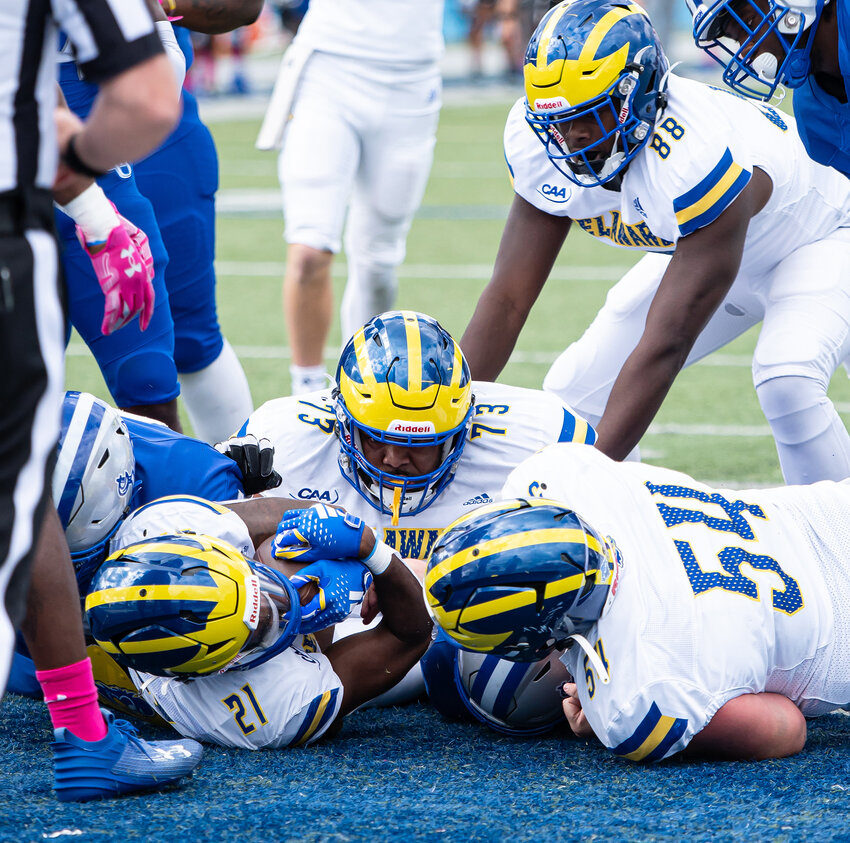 The Hens' Marcus Yarns (21) scores a TD with the help of Dover High grads Bradly Anyanwu (73) and Elijah Sessom (88). University of Delaware Athletics photo.