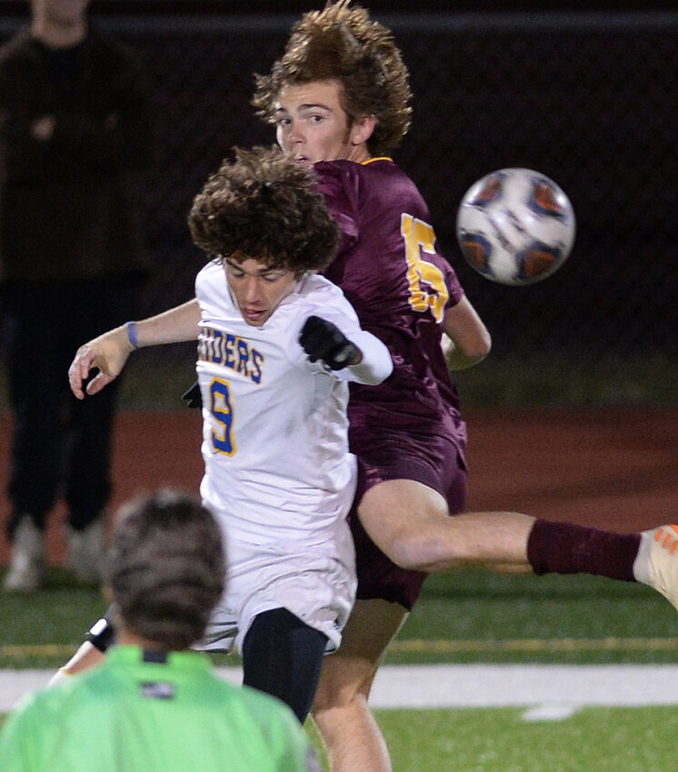 William Victory of Caesar Rodney heads the ball away from a Milford&rsquo;s Thomson Burke in first half of match played Tuesday night.  SPECIAL TO THE DELAWARE STATE NEWS/GARY EMEIGH