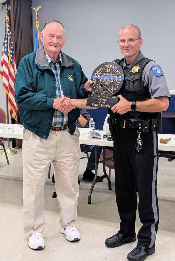 Paul Davis, left, is presented the Active Member of the Year Award by Fraternal Order of Police Lodge 3 president Chris Guild.