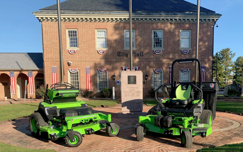 The city of Dover is using an Energize Delaware grant to purchase two commercial Greenworks electric riding mowers (shown in front of City Hall), a Chevrolet Bolt and six Ford F-150 Lightning pickup trucks.