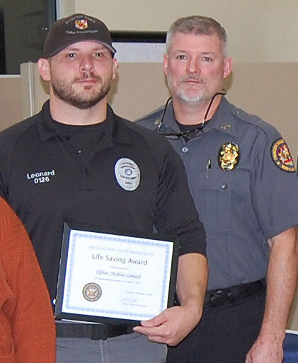 Princess Anne Police Officer Nicholas Leonard with his Life Saving Award, presented by Chief Robert Wink.