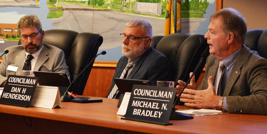 Seaford City Councilman Mike Bradley, right, offers his opinion to a proposed ban on production and retail sales of marijuana during a meeting Tuesday. City manager Charles Anderson, left, and Vice Mayor Dan Henderson listen in.