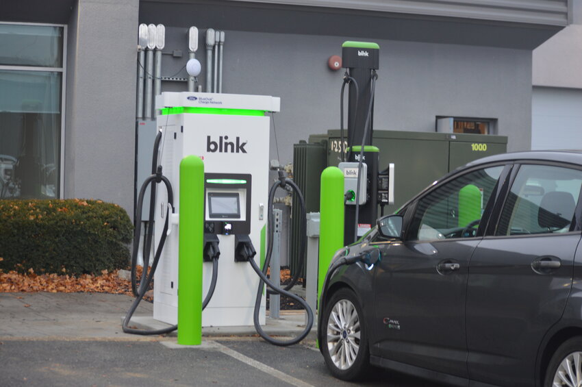 A zero-emission vehicle charges at a Blink charging outlet at Porter Ford in Newark on Friday, just outside of the University of Delaware campus.