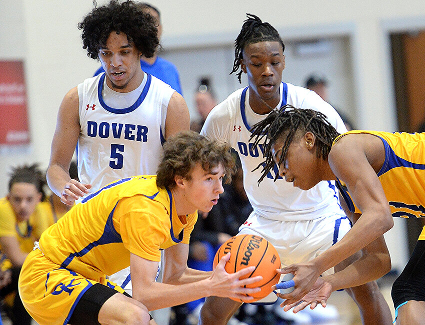 Special to the Daily State News/Gary Emeigh  Senior guard Adam Bailey (left). one of CR&rsquo;s captains this season, fights for a loose ball in a game against Dover last season.