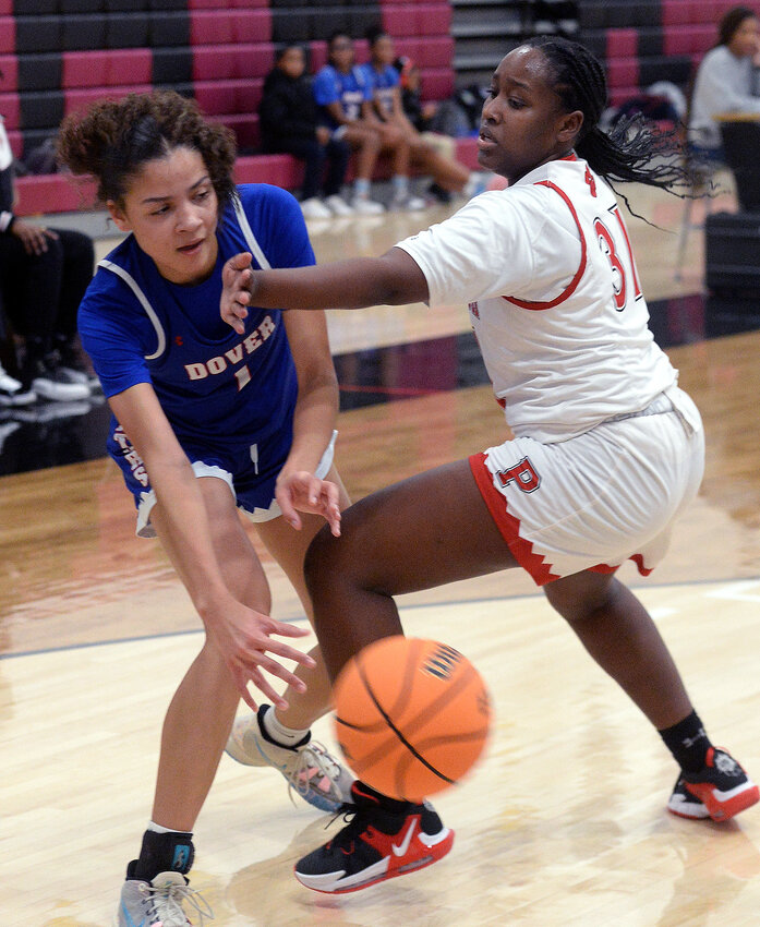 Malya Milstead of Dover manages to get a pass to a teammate around Polytech defender Marie Cadet.  SPECIAL TO THE DAILY STATE NEWS/GARY EMEIGH