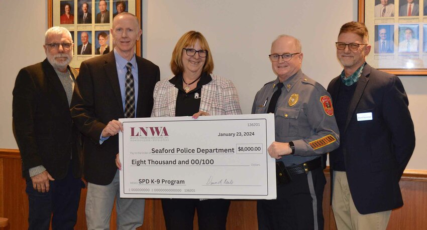 Arbor Management made an $8,000 donation to the Seaford Police Department's new K-9 program at Tuesday's City Council meeting. From left are Vice Mayor Dan Henderson, Arbor Management's director of security Jim Fitzgerald and its vice president Denise Neal, Police Chief Marshall Craft Jr. and Mayor David Genshaw.