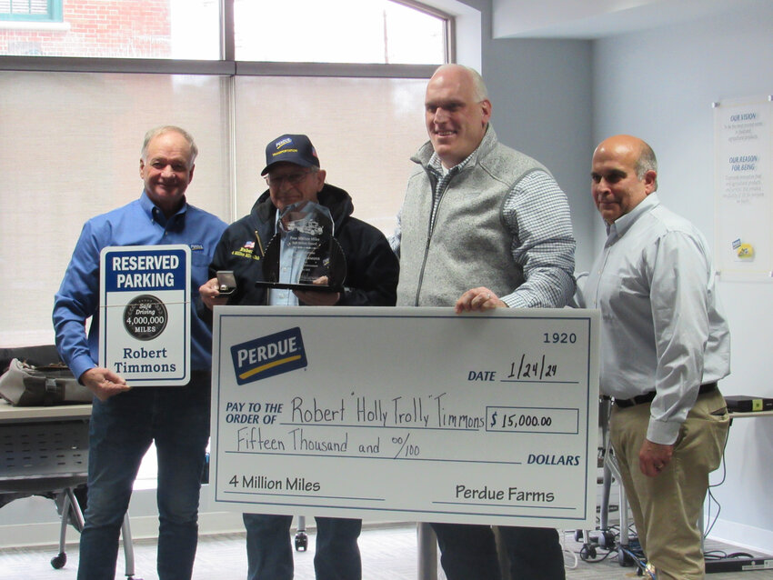 Perdue Farms awarded Robert Timmons with a check, jacket, plaque, ring and reserved parking sign to recognize his driving 4 million miles safely. From left are Jim Perdue, chair of the company; Mr. Timmons; CEO Kevin McAdams; and Christopher Trajkovski, vice president of transportation.