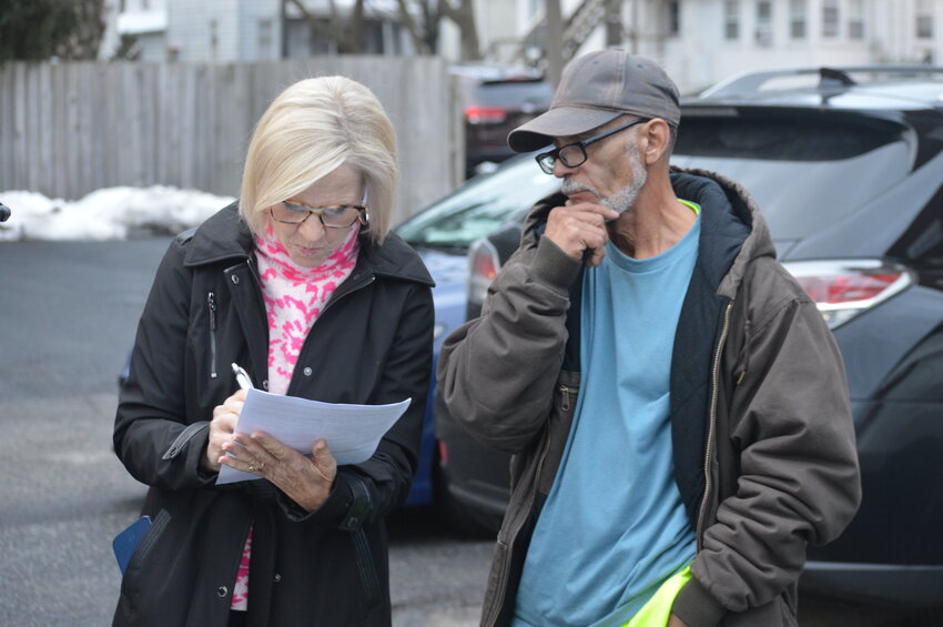 Lt. Gov. Bethany Hall-Long helps a man complete a sheltered survey outside of the People's Church in Dover.