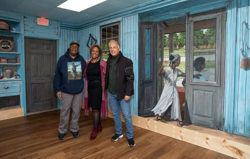 From left, Harriet Tubman Museum and Education Center President Bill Jarmon and Executive Director Linda Harris join artist Michael Rosato during the official presentation of the &quot;Minty's Act of Courage&quot; mural recreating the Bucktown General Store, site of Harriet Tubman's first act of defiance.