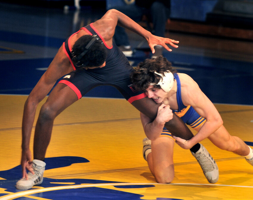 Alexander Batton of Caesar Rodney tries for a takedown in the 126-pound match against MyKahy Pritchett of William Penn.  Batton won the bout with a 10-2 major decision.  SPECIAL TO THE DAILY STATE NEWS/GARY EMEIGH