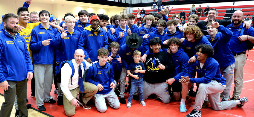 The Golden Knight wrestling team poses for photos after they won the DIAA Division I state title, 36-34, against Cape Henlopen Saturday night.  SPECIAL TO THE DAILY STATE NEWS/GARY EMEIGH