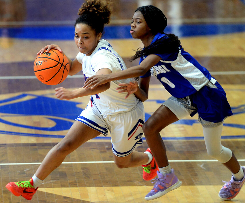 Lily Harper of Dover works the ball around Woodbridge defender  in Ajaia Cannon in Saturday&rsquo;s Henlopen Conference championship game.  SPECIAL TO THE DAILY STATE NEWS/GARY EMEIGH