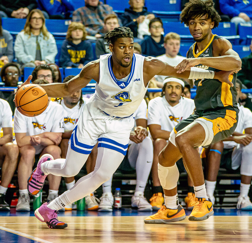 The Blue Hens&rsquo; Gerald Drumgoole, Jr. looks to drive past a Drexel defender on Monday night&rsquo;s game. Delaware Athletics photos/Mikey Reeves
