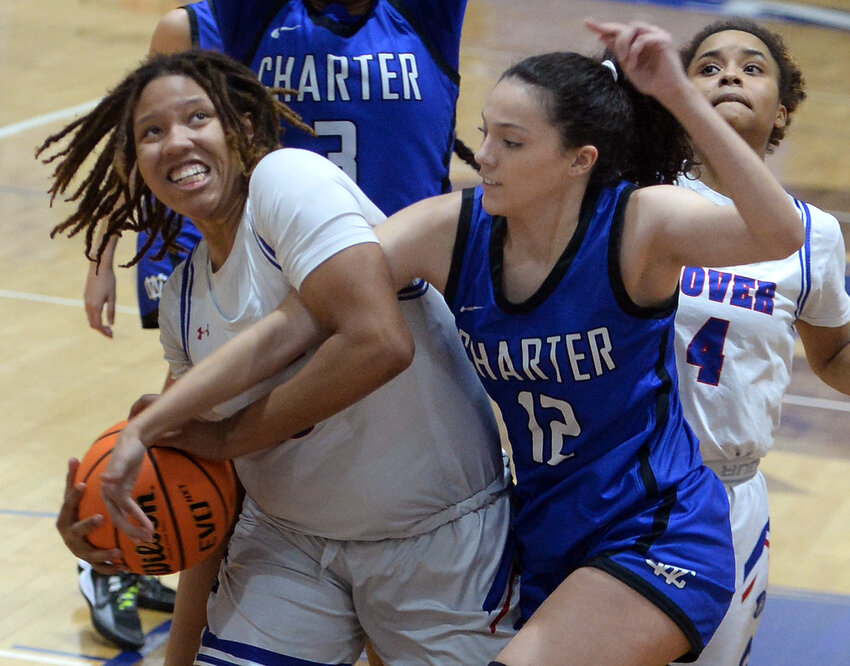 Sara Benson of the Senators pulls down her own rebound along with the arm of Wilmington Charter's Danielle Kanse.  SPECIAL TO THE DAILY STATE NEWS/GARY EMEIGH