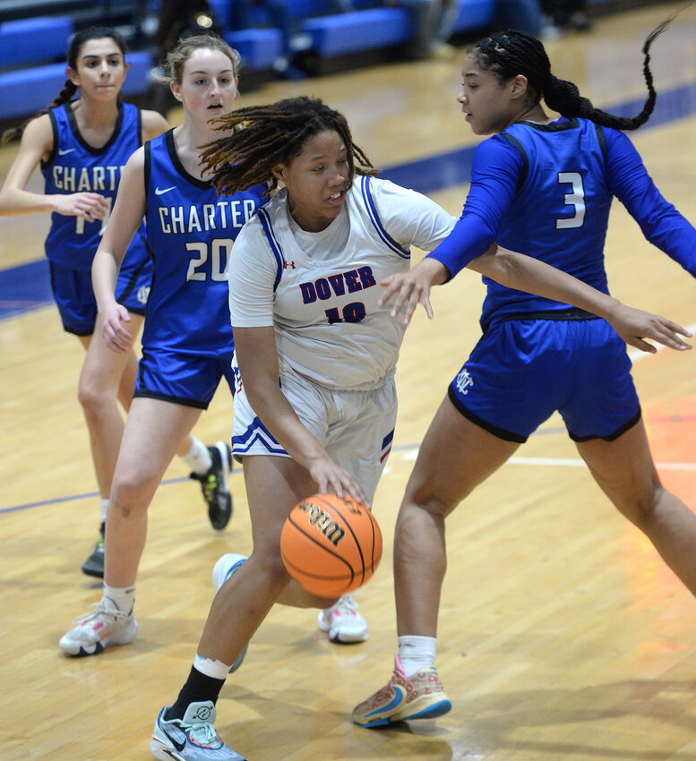 Sara Benson of Dover trying to drive to the basket around Wilmington Charter defender Morgan Robinson.  SPECIAL TO THE DAILY STATE NEWS/GARY EMEIGH