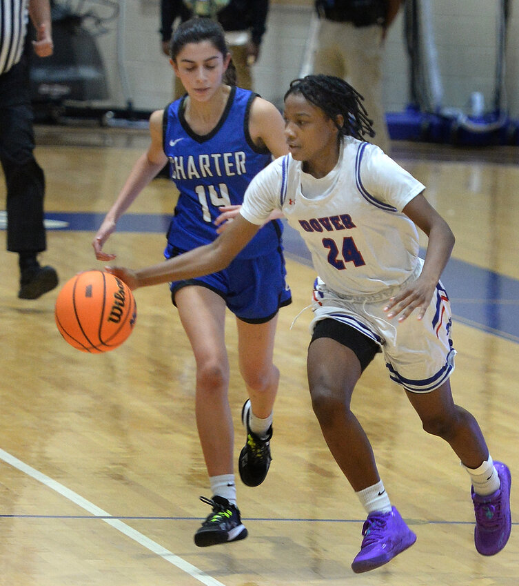 Dover freshman Amani Sudler races ahead of Charter defender Danielle Al-Annouf on a fast break in the first half Wednesday night.  SPECIAL TO THE DAILY STATE NEWS/GARY EMEIGH