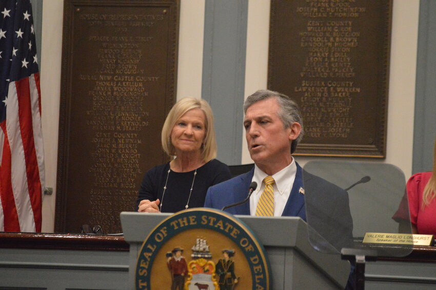 Gov. John Carney, flanked by Lt. Gov. Bethany Hall-Long, addresses a packed House chamber that featured legislators, statewide elected officials and Cabinet members Tuesday.