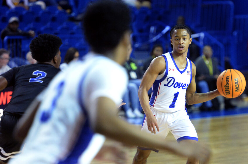 Dover point guard Denim Perkins tries to get a pass to teammate Dorell Little (3) in Thursday night&rsquo;s DIAA state semifinal game played at the University of Delaware. Perkins had 10 assists in the game. SPECIAL TO THE DAILY STATE NEWS/GARY EMEIGH