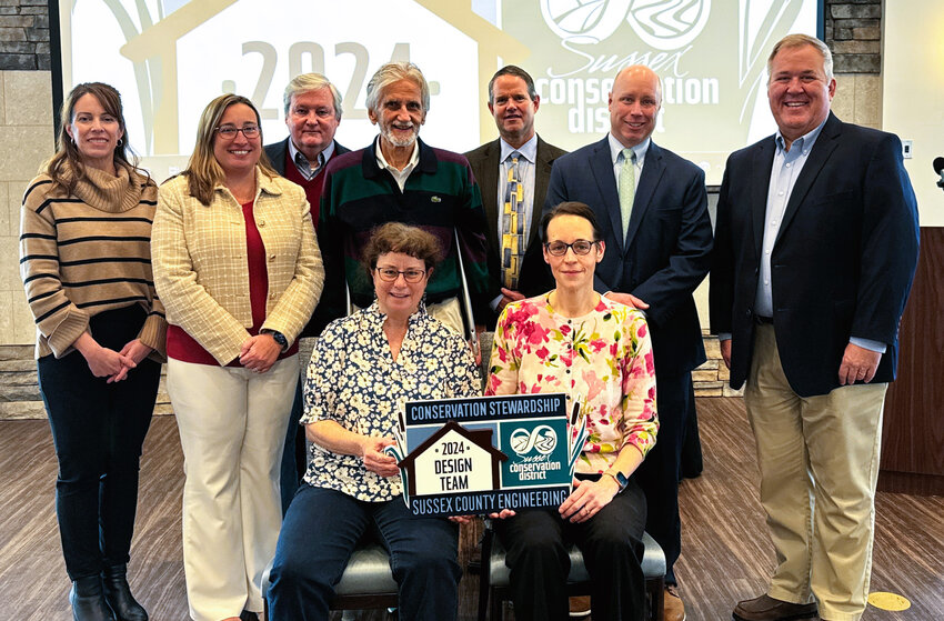 Sussex County Engineering accepts the 2024 Conservation Stewardship Award for design team March 7 for the Inland Bays Regional Wastewater Facility. From left, front row, Helen Naylor and Valerie Thompson, project engineers. Back row, Jessica Watson, Sussex Conservation District sediment and stormwater program manager, Gina Jennings, Sussex County finance director, John Rieley, Sussex County Council vice president and Sussex Conservation District board member, Hans Medlarz, ret. county engineer, Mike Harmer, county engineer, Todd Lawson, county administrator, and David Baird, Sussex Conservation District district coordinator.