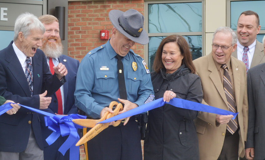 Ceremony participants share a laugh, as Millsboro Police Chief Brian Calloway cuts the ribbon for the police department on Wednesday. From left are Millsboro Mayor Jim Kells, town manager Jamie Burk, Chief Calloway, Greater Millsboro Chamber of Commerce president Anne Angel, state Rep. Rich Collins and state Sen. Brian Pettyjohn.