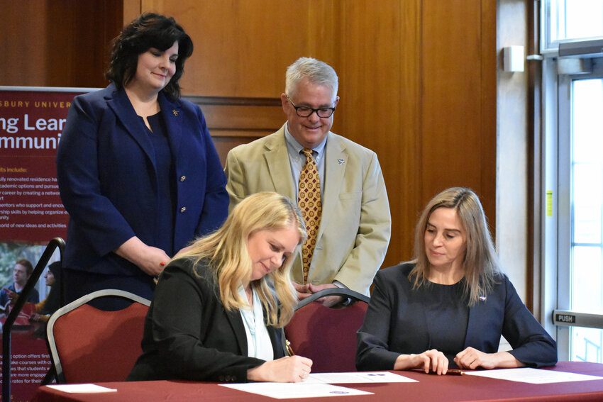 Provost Dr. Laurie Couch and NASA Wallops Flight Facility director David Pierce look on as Salisbury University President Dr. Carolyn Ringer Lepre and NASA Goddard Space Flight Center director Dr. Makenzie Lystrup sign a formal partnership between the two organizations March 28.