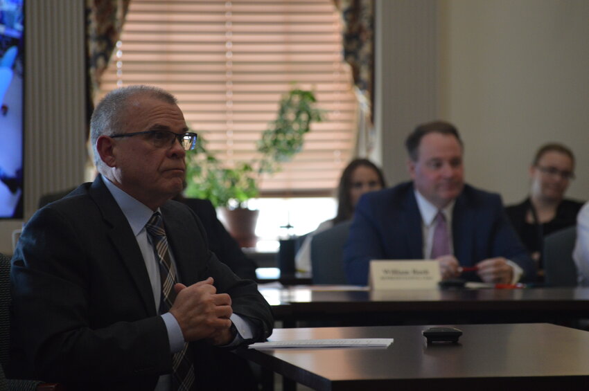 Rep. Ed Osienski, D-Newark, (left) speaks during the House Economic Committee on Tuesday. The measure extends legal protections for financial institutions ahead of Delaware's upcoming retail marijuana market.