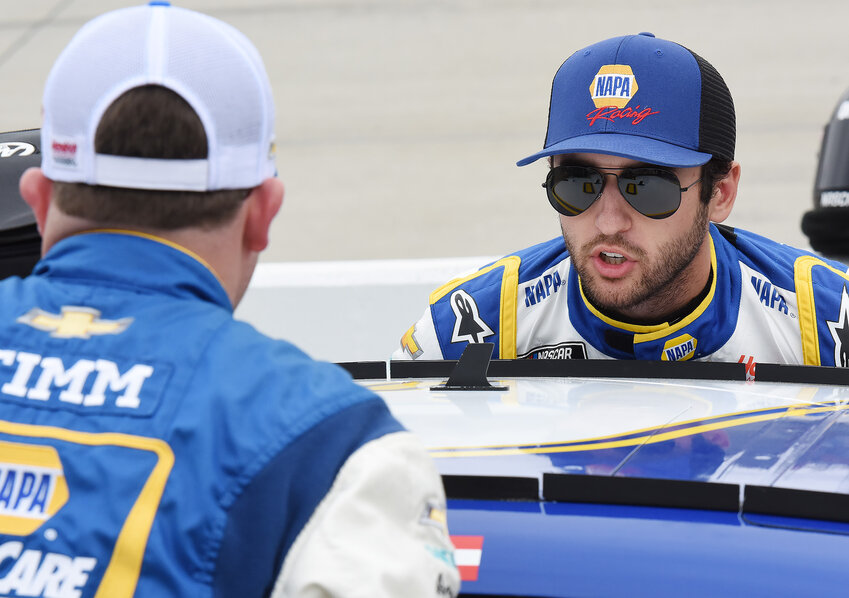Chase Elliott, driver of the No. 9 NAPA Chevrolet, talks with a crew member prior to the start of Cup Series race at Dover in 2022.