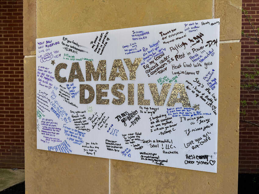 Messages of remembrance from the community are displayed at Camay DeSilva's memorial at Delaware State University.