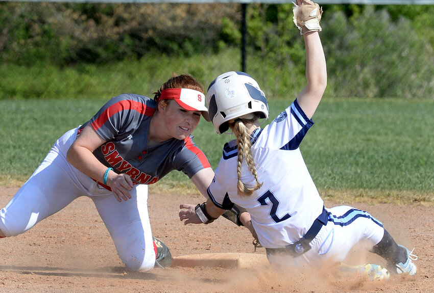 Smyrna shortstop Skylar Clark puts a tag on Kaitlyn Pierce of Lake Forest who tried to steal second base in the bottom of the first inning Thursday.  SPECIAL TO THE DAILY STATE NEWS/GARY EMEIGH