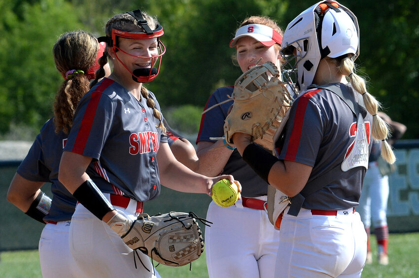 Smyrna pitcher Alexis Dennis (left) and her teammates smiling after they tied the score in Thursday's game with Lake Forest.  SPECIAL TO THE DAILY STATE NEWS/GARY EMEIGH