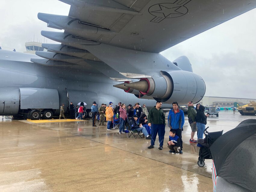 The massive wings on the C-5M Super Galaxy provided shelter from a persistent rain shower on Saturday at the First State Air Show at Dover Air Force Base.
