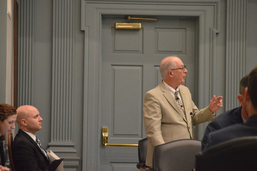 Rep. Danny Short, right, a member of the state's budget-forecasting committee, speaks in opposition to the proposed hospital cost review board Tuesday, as Delaware Healthcare Association president Brian Frazee looks on.