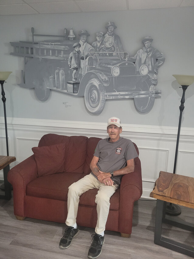 Clayton Fire Co. No. 1 60-year-member Robert Faulkner is shown below a rendering of an old firetruck.