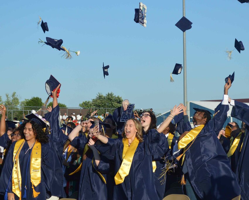 Seaford High School Class of 2024 graduates celebrate by tossing their caps at the conclusion of Friday night's ceremony.