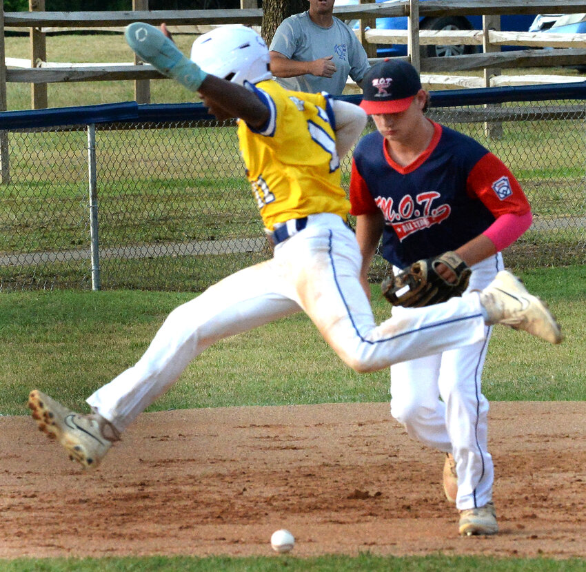 M.O.T. shortstop Noah Wegman runs up to field a grounder with Makai Parker of Camden-Wyoming avoiding the ball as he heads to third.  SPECIAL TO THE DAILY STATE NEWS/GARY EMEIGH