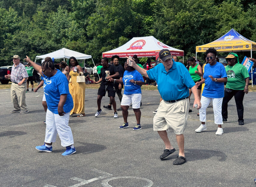 Dover City Councilman Bill Hare dances with the First State Steppers at Unity Day on Saturday.