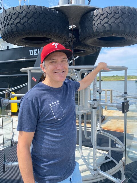 Dr. Andrew Wozniak displays the device he and his team are using to collect data on gas and particle exchange between the ocean and the atmosphere.