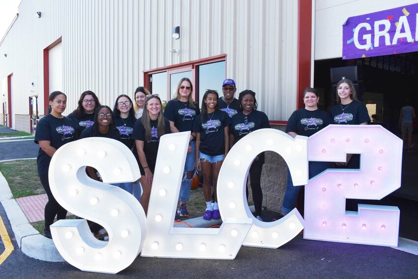 Supreme Loyalty Cheer members stand outside their new location during a grand opening Oct. 5.